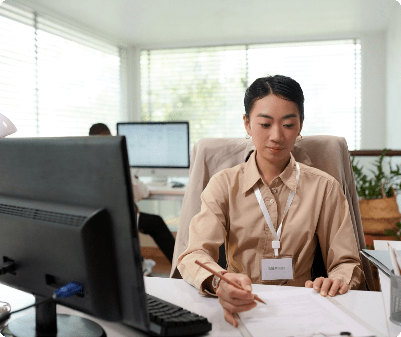 Professional woman at a desk, reviewing documents